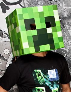 a man wearing a creeper mask in front of a wall