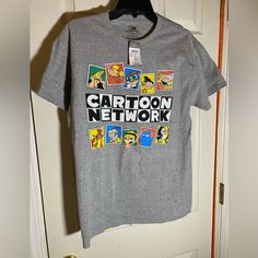 a gray t - shirt with cartoon network on it hanging from a door hanger