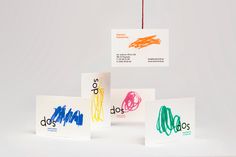 three greeting cards with different colored crayons on them, hanging from strings in front of a white background