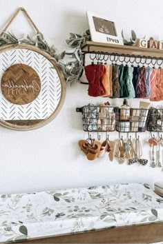 there is a shelf with many pairs of shoes hanging on it next to a bed