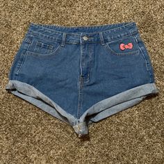 These Jean Shorts Feature Hello Kitty’s Signature Red Bow Above The Left Front Pocket And Hello Kitty’s Face On The Right Back Pocket. They Are Slightly High Waist And Have One Front Button And A Zipper. They Are Size Large And Fit Me Snug. I Wear A Size 4/6 In American Eagle Jeans. Cute Fitted Bottoms, Cute Red Stretch Bottoms, Cute Denim Jean Shorts, Cute High Waist Cotton Bottoms, Cute Stretch Blue Shorts, Cute Blue Stretch Shorts, Cute High-waist Cotton Bottoms, Cute Fitted Shorts, Cute Fitted Short Length Shorts