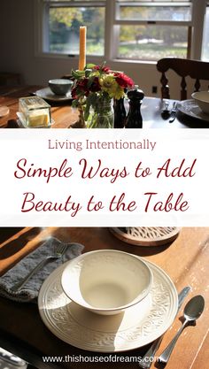 a wooden table topped with white plates and flowers