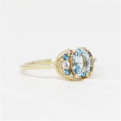 Discover the unique charm of the LeConte Impasto Collection with this handcrafted 14K yellow gold artisan fashion ring, size 6. Designed for those who appreciate the beauty of art and nature, this exquisite piece features a central 0.97ct oval aquamarine, enveloped by an array of stunning gemstones.Key Features:-Exceptional Craftsmanship: Each ring is a masterpiece from the LeConte Impasto Collection, reflecting the pinnacle of artisanal skill.-Captivating Centerpiece: A mesmerizing 0.97ct oval Unique Oval Yellow Gold Topaz Ring, Unique Yellow Gold Oval Moonstone Ring, Unique Oval Yellow Gold Moonstone Ring, 14k Gold Celestial Oval Rings, Unique Oval Moonstone Ring In Yellow Gold, Blue Oval Moonstone Ring In 14k Gold, Handmade Oval Sapphire Ring In 14k Gold, Unique Oval Cluster Ring In Yellow Gold, Celestial Oval Yellow Gold Rings