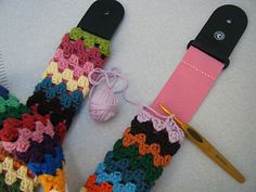 a pair of crocheted mitts next to a comb and ball of yarn