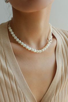 This stunning necklace features an elegant blend of 8mm natural white mother-of-pearl and delicate millet pearls, creating a chic half-and-half design that is both eye-catching and fashionable. With its sophisticated yet modern aesthetic, this piece brings an air of elegance and grace to any outfit. Whether paired with a dress, blazer, or knitwear, it adds a soft and refined touch, making it the perfect accessory for a variety of styles. Metal: Recycled Sterling Silver Plated On Brass Material: Pearl Necklace Modern, Pearl Necklaces Modern, Sliver Earrings, Tiger Eye Stone, Beaded Choker Necklace, Enamel Earrings, Stunning Necklace, Metal Earrings, Beaded Choker