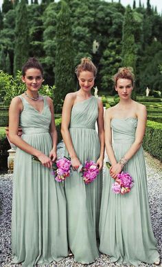 three bridesmaids in green dresses holding bouquets