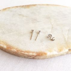 This pair of tiny sapphire stud earrings are made of white or yellow gold vermeil over sterling silver. They are super tiny. Only 2mm. Measurements: Width - 2mm S for Sparkle on Etsy https://www.etsy.com/shop/sforsparkleshop -------------------------------------------------------------------- S for Sparkle Mission We believe that everyone should have the power and access to practice self-validation. We strive to empower people with reminders of their inner values and worthiness through thoughtfu Hypoallergenic White Gold Nose Studs As Gift, Classic Tiny Earrings For Anniversary, Fine Jewelry Cartilage Earrings With Prong Setting As Gift, Dainty Silver Diamond Earrings For Everyday, Yellow Gold Nose Studs With Prong Setting For Gift, Dainty Prong Setting Nose Studs As Gifts, Classic Round Nose Studs For Gifts, Classic Hypoallergenic Nose Studs Gift, Sterling Silver Earrings With Prong Setting For Everyday