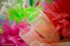 several different colored paper flowers on display