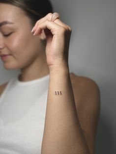 a woman with a small tattoo on her arm