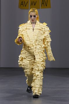 a man in a yellow suit made out of paper