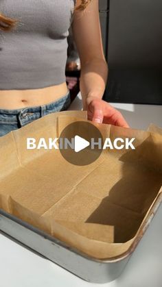 a woman holding a brown paper bag with the words baking hack on it in front of her