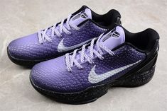 a pair of purple and black nike shoes