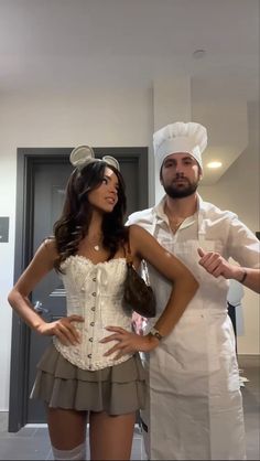 a man and woman dressed up as chefs standing next to each other in the kitchen