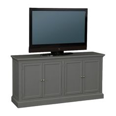 a flat screen tv sitting on top of a gray entertainment center with doors and drawers