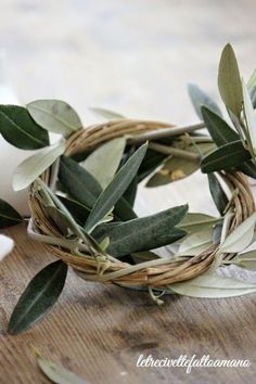 an olive wreath is sitting on top of a wooden table