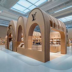 the inside of a louis vu store with an arch shaped display in front of it