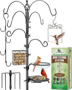 the bird feeder stand has two birds on it and is next to a box of seed