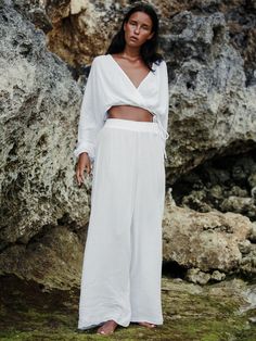 The Siena Top White’s cross-front drape adds a romantic silhouette to your look. Flowing material feels irresistibly breezy with wide sleeves is perfect for strolls in the sand or layering over a transitional look. Featuring a double gauze muslin cotton, the fabric helps you to feel ultra comfy during the warmer days. - 100% Turkish double layered gauze cotton - Wide sleeves- V shaped front drape with hidden optional closure - Adjustable drawstring waistband; elasticated waist- One size fits most Romantic Silhouette, Laptop Tote Bag, Vegan Leather Bag, Skirt Jumpsuit, Resort Collection, Double Gauze, Swim Accessories, Muslin Cotton