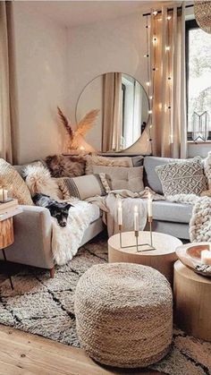 a living room filled with lots of furniture and candles on top of it's tables