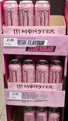 pink monster energy drinks are on display in a store