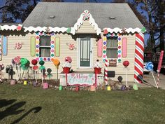 a house decorated for christmas with candy canes and lollipops on the windows