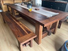 a wooden table and bench in a room