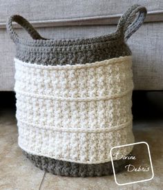 a crocheted basket is sitting on the floor