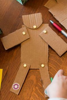 someone is making a paper doll out of cardboard