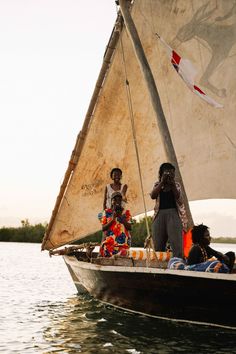 three people on a small boat in the water