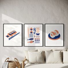 three framed pictures hang on the wall above a couch in a living room with a wicker basket