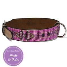 a purple and black dog collar with a brown leather buckle on it's side