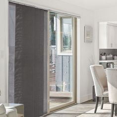 a dining room and kitchen area with sliding glass doors