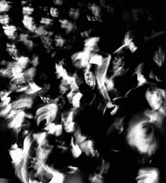 black and white photograph of people in the crowd with blurry image on their face