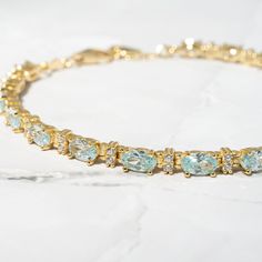 "This beautiful, vibrant tennis bracelet features alternating oval-cut aquamarine and round solitaire stones. It looks great stacked or on its own! It is a unique piece that's one-of-a-kind and beautiful!! - - - D E T A I L S  - - - * Made of 925 Sterling Silver * THICK plating of 14k Gold or Rhodium  * Available in 6.25\" or 6.75\"  or 7\" + .5\" Extension  * Lobster Clasp Closure  * Nickel-free & Hypoallergenic  * Made of Highest Grade CZ stones for an authentic Aquamarine look! Made with 100% Pure Love! ♡ Happy to answer any questions you may have! 🥰 Let's Connect! 🥰 IG: samijewels_" Jewelry Gold Bracelet, Gold Bracelet Set, Aquamarine Bracelet, Bracelet Tennis, Cz Bracelet, Round Solitaire, Gold Armband, Adjustable Jewelry, Aquamarine Jewelry