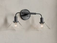 two light fixtures mounted on a wall next to each other