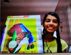 a girl with dreadlocks standing in front of a painting