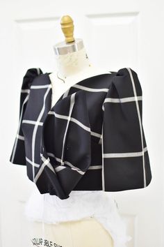 a mannequin wearing a black and white checkered top