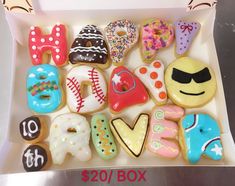 a box filled with lots of decorated donuts in different shapes and sizes on top of each other