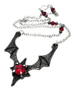 Made to Order! Dramatic, imposing and vampiric as you are, this bat wing necklace will complete your nocturnal ensemble. Stalk the halls of your dwelling or favorite events and capture the attention of your fellow night creatures with its unique design, sculpted in our studio. The pendant is cast in lead free pewter by Gothic Red Necklace For Cosplay, Red Gothic Necklace For Cosplay, Gothic Horned Jewelry For Halloween, Gothic Winged Jewelry For Gifts, Gothic Winged Jewelry Gift, Gothic Horned Metal Jewelry, Horned Gothic Metal Jewelry, Vampire Style Necklaces For Halloween Cosplay, Handmade Vampire Necklaces For Halloween