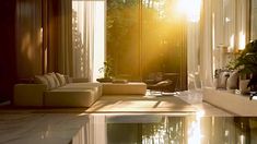 the sun shines brightly through the curtains in this living room with water reflecting on the floor