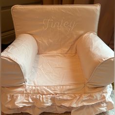 a white chair with the word funky on it's back and ruffled seat