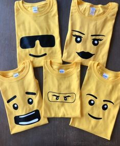 four yellow tshirts with faces drawn on them, all in different shapes and sizes