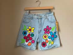 "Label * Dakota Blue | Decade * 1990s | Color * Blue/Multi Vintage light blue stonewash denim shorts. colorful patchwork appliqué flowers with distressed/frayed areas. high waist. Button front & zip fly closure. 5 pocket styling. Fabric content: 100% cotton ❉ Super cute 90s girl shorts! Modern size estimate: M/L (Tag reads a vintage size 13/14) ⦿ Waist: 29/30\" ⦿ Hips: 40\" ⦿ Rise: 12\" ⦿ Inseam: 7\" ⦿ Length: 17\" All measurements are taken flat. Condition: Excellent! ❉ this is a vintage it 90s Style Cotton Jean Shorts For Spring, 90s Inspired Denim Jean Shorts For Spring, Multicolor Cutoff Jean Shorts For Spring, Retro Cutoff Jean Shorts For Spring, Spring Multicolor Cutoff Jean Shorts, Multicolor Denim Jean Shorts For Spring, Spring Multicolor Denim Jean Shorts, 90s Denim Shorts For Spring, 90s Inspired Jean Shorts For Spring