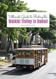 a trolley driving down the street in front of a building with a sign that says ultimate guide to riding the waiki trolley in hawaii