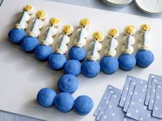 blue and white cupcakes arranged in the shape of train tracks