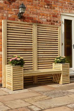 two wooden planters sitting next to each other near a brick wall with shutters