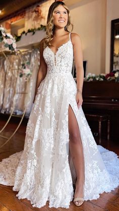 a woman in a white wedding dress posing for the camera with her leg high on the floor