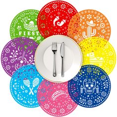 a plate with a fork and knife on it in front of colorful mexican paper plates