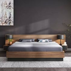 a modern bedroom with grey walls and wooden furniture, including a bed frame that has two nightstands on each side