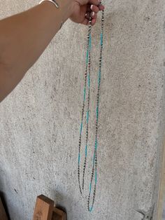 Expertly crafted by Navajo artist Lucinda Sardo, this 100" Wrap Around Turquoise and Pearls Necklace exudes elegance and cultural significance. The luminous pearls and vibrant turquoise beads are skillfully strung together, creating a versatile piece that can be worn long or wrapped around multiple times. Elevate any outfit with this timeless and authentic Navajo necklace. Hand-strung Western Turquoise Necklace, Western-style Hand-strung Turquoise Necklace, Southwestern Adjustable Turquoise Necklace Hand-strung, Navajo Turqoise Necklace, Adjustable Southwestern Hand-strung Turquoise Necklace, Navajo Necklace, Pearls Necklace, Kids Earrings, Turquoise Beads